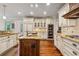 Gourmet kitchen with granite countertops, custom cabinetry, and modern appliances at 6935 Wakehurst Pl, Cumming, GA 30040