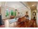 Bright living room with hardwood floors, large windows, and elegant furniture for comfortable living at 6935 Wakehurst Pl, Cumming, GA 30040