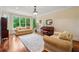 Elegant living room with hardwood floors, bay window, and comfortable seating area at 6935 Wakehurst Pl, Cumming, GA 30040