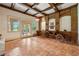 Unique living room with brick accent wall, exposed beams, and antique carriage decor at 6935 Wakehurst Pl, Cumming, GA 30040