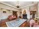 Inviting living room featuring hardwood floors, fireplace, and a built-in hutch for storage and style at 6935 Wakehurst Pl, Cumming, GA 30040