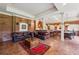 Spacious living room with brick accent walls, leather sofas, and a wet bar at 6935 Wakehurst Pl, Cumming, GA 30040
