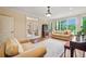 Bright living room with hardwood floors, bay window, and french doors leading to another room at 6935 Wakehurst Pl, Cumming, GA 30040