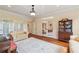 Well-lit living room with hardwood floors, french doors, and an antique book case at 6935 Wakehurst Pl, Cumming, GA 30040
