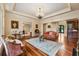 Spacious living room with hardwood floors, a large rug, and elegant furnishings for a comfortable atmosphere at 6935 Wakehurst Pl, Cumming, GA 30040