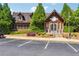 Exterior view of a charming real estate office, showcasing its welcoming entrance and well-maintained landscaping at 6935 Wakehurst Pl, Cumming, GA 30040