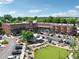 Aerial view of a charming town center, complete with green spaces, shops, and a community gathering area at 6935 Wakehurst Pl, Cumming, GA 30040