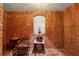 Rustic wine cellar featuring exposed brick walls and beverage storage at 6935 Wakehurst Pl, Cumming, GA 30040