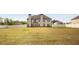 Large backyard with a big grassy area and a tall white fence all around at 209 Brynn Ln, Mcdonough, GA 30252