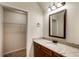 Bathroom featuring a granite countertop, wood cabinetry, and walk-in closet at 209 Brynn Ln, Mcdonough, GA 30252