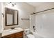 Bathroom featuring granite countertops, warm wood cabinets, and combined shower and tub at 209 Brynn Ln, Mcdonough, GA 30252