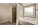 Modern bathroom featuring a tiled shower, soaking tub, and a window for natural lighting at 209 Brynn Ln, Mcdonough, GA 30252