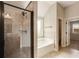 Beautiful bathroom showcasing a separate tiled shower, soaking tub, and ample natural light at 209 Brynn Ln, Mcdonough, GA 30252