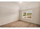 Bright bedroom featuring neutral paint, plush carpet, and a large window with natural light at 209 Brynn Ln, Mcdonough, GA 30252