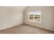 Bedroom featuring neutral paint, plush carpet, and a large window with natural light at 209 Brynn Ln, Mcdonough, GA 30252