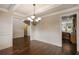 Bright dining room with hardwood floors, wainscoting, and decorative chandelier at 209 Brynn Ln, Mcdonough, GA 30252
