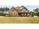 Two-story brick and siding home with a well-manicured lawn and covered front porch at 209 Brynn Ln, Mcdonough, GA 30252