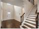 Bright foyer with hardwood floors, staircase, and natural light streaming through the front door at 209 Brynn Ln, Mcdonough, GA 30252