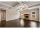 Bright living room features a coffered ceiling, stone fireplace and seamless flow and hardwood floors at 209 Brynn Ln, Mcdonough, GA 30252