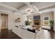 Bright living room features a coffered ceiling, stone fireplace and seamless flow and hardwood floors at 209 Brynn Ln, Mcdonough, GA 30252