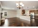 Bright living room open to kitchen with granite countertops, stainless appliances, and modern hardwood floors at 209 Brynn Ln, Mcdonough, GA 30252