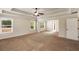 Expansive carpeted main bedroom boasting a tray ceiling, ceiling fan, and plenty of natural light at 209 Brynn Ln, Mcdonough, GA 30252