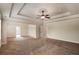 Vast main bedroom with a tray ceiling, ceiling fan, and neutral carpet, offering ample space at 209 Brynn Ln, Mcdonough, GA 30252