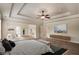 Elegant main bedroom showcasing tray ceilings, ceiling fan, sitting area, and generous space at 209 Brynn Ln, Mcdonough, GA 30252