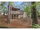 Back exterior view of the home featuring a large deck and plenty of backyard foliage at 2763 Macby Walk, Marietta, GA 30066