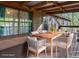 Virtually staged covered deck with table and chairs overlooking wooded backyard at 2763 Macby Walk, Marietta, GA 30066