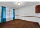 Empty dining room features hardwood floors, white walls, and blue curtains at 2763 Macby Walk, Marietta, GA 30066