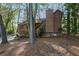 Charming house with wood siding, nestled among mature trees in a serene, wooded setting with stone foundation at 2763 Macby Walk, Marietta, GA 30066