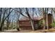 Charming house with wood siding, nestled among mature trees in a serene, wooded setting with stone foundation at 2763 Macby Walk, Marietta, GA 30066