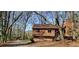 Charming house with wood siding, nestled among mature trees in a serene, wooded setting with stone foundation at 2763 Macby Walk, Marietta, GA 30066
