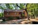 Charming house with wood siding, nestled among mature trees in a serene, wooded setting with stone foundation at 2763 Macby Walk, Marietta, GA 30066