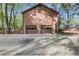 Spacious two-car garage with traditional doors, nestled among mature trees in a private wooded setting at 2763 Macby Walk, Marietta, GA 30066
