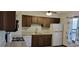 Functional kitchen featuring wood cabinets, white appliances, and granite countertops, creating a practical space at 2763 Macby Walk, Marietta, GA 30066