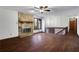 Spacious living room featuring wood floors, a stone fireplace, and a railing, creating a cozy atmosphere at 2763 Macby Walk, Marietta, GA 30066