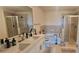 Bathroom featuring double sink vanity, tub and separate glass shower at 3324 Peachtree Ne Rd # 905, Atlanta, GA 30326