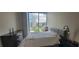Cozy bedroom featuring neutral decor, city view, and wood flooring at 3324 Peachtree Ne Rd # 905, Atlanta, GA 30326