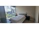 A bedroom featuring modern decor and a view of the city from a large window at 3324 Peachtree Ne Rd # 905, Atlanta, GA 30326