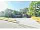 The charming exterior of the home features a spacious yard and ample parking at 380 Amal Sw Dr, Atlanta, GA 30315