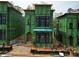 New construction exterior view showing modern design with black window frames and green sheathing at 11863 Serenbe Ln, Chattahoochee Hills, GA 30268