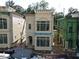 Two-story home with large windows, detailed trim, and an arched entryway at 11863 Serenbe Ln, Chattahoochee Hills, GA 30268