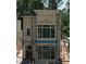 New construction home featuring multi-pane windows, architectural details, and scaffolding at 11863 Serenbe Ln, Chattahoochee Hills, GA 30268