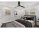 Well-lit bedroom features a ceiling fan, two windows, and dark-wood floors at 2760 Swansea Ct, College Park, GA 30349