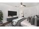 Bedroom features a ceiling fan, mounted TV, grey floors, and access to the kitchen at 2760 Swansea Ct, College Park, GA 30349