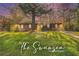 Charming renovated home with lush green lawn and mature landscaping, with 'The Swansea' script overlay at 2760 Swansea Ct, College Park, GA 30349