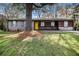 Charming single-story home with a well-maintained lawn, inviting curb appeal, and a bright yellow front door at 2760 Swansea Ct, College Park, GA 30349