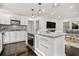 Kitchen with stainless appliances, granite counters, white cabinetry and an island open to the living room at 2760 Swansea Ct, College Park, GA 30349